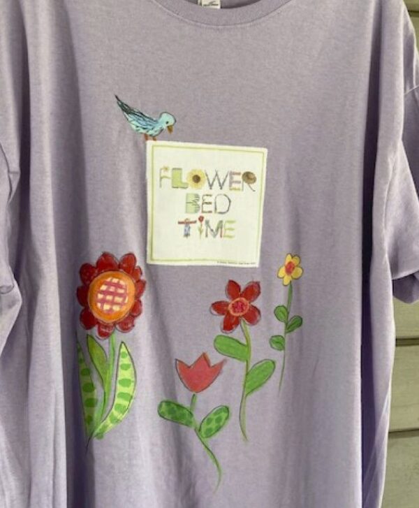 A t-shirt with flowers and a bird on it.