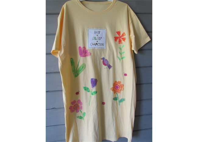 A yellow Sleepshirt - Eat • Sleep • Garden with flowers on it.