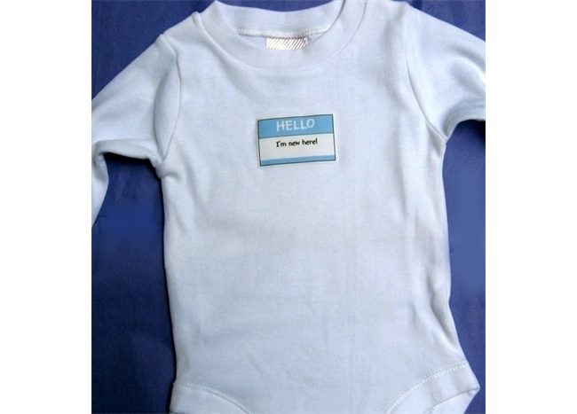 A blue Baby Onesie - Hello I'm New Here with a name tag on it.
