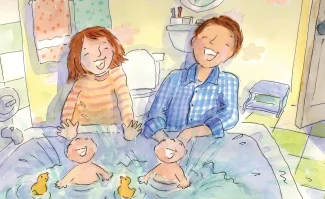 A man and woman playing with two babies.